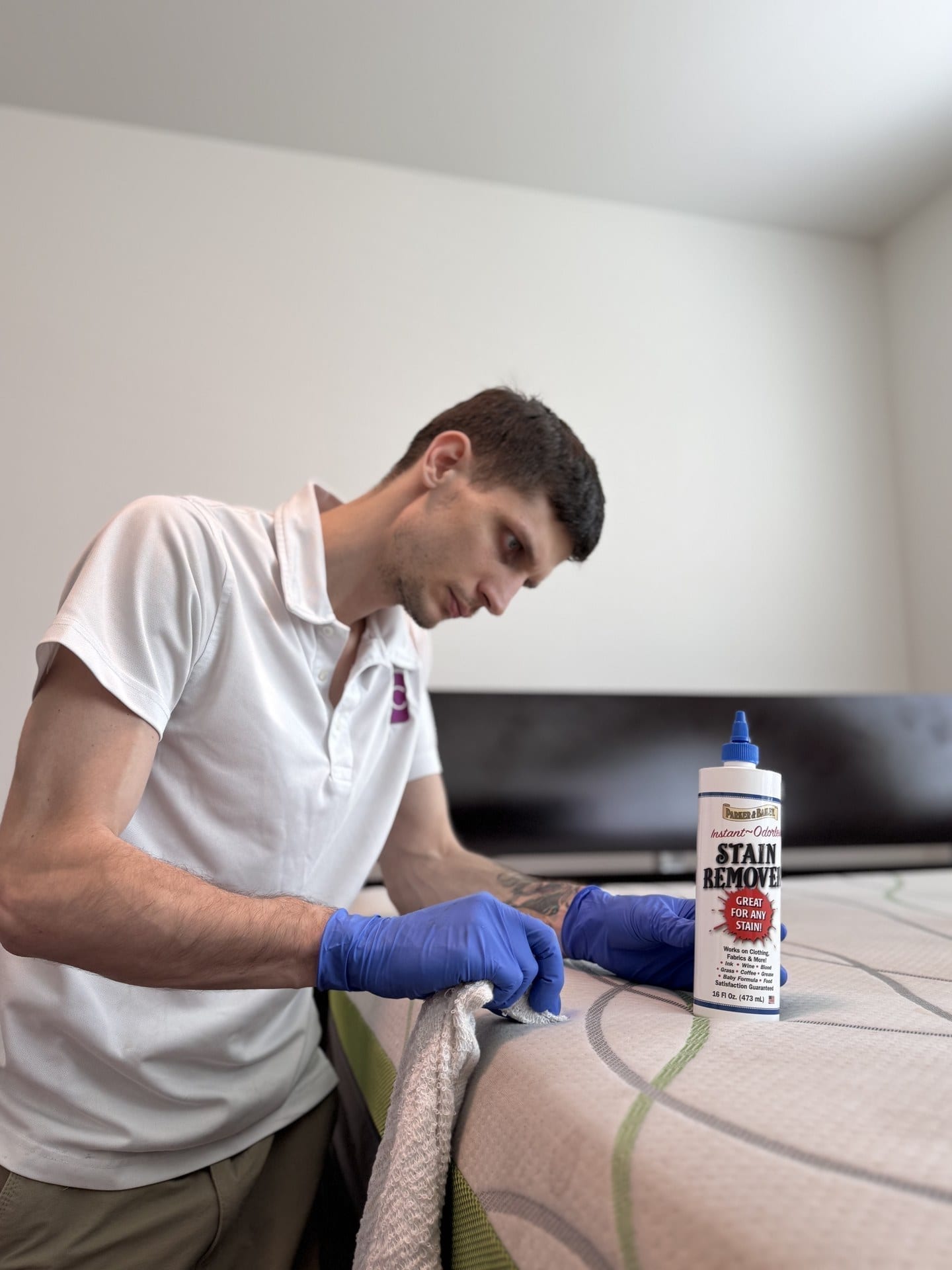 MagiClean technician treating a stain on a mattress during an upholstery cleaning visit